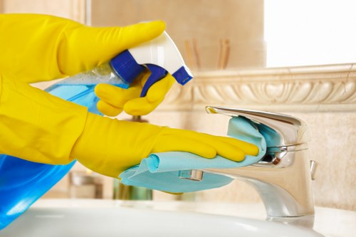 Team member using safe cleaning procedures in a workplace