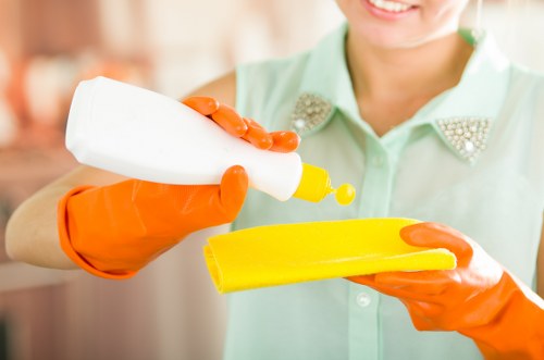 Professional cleaner maintaining a communal corridor in Watford